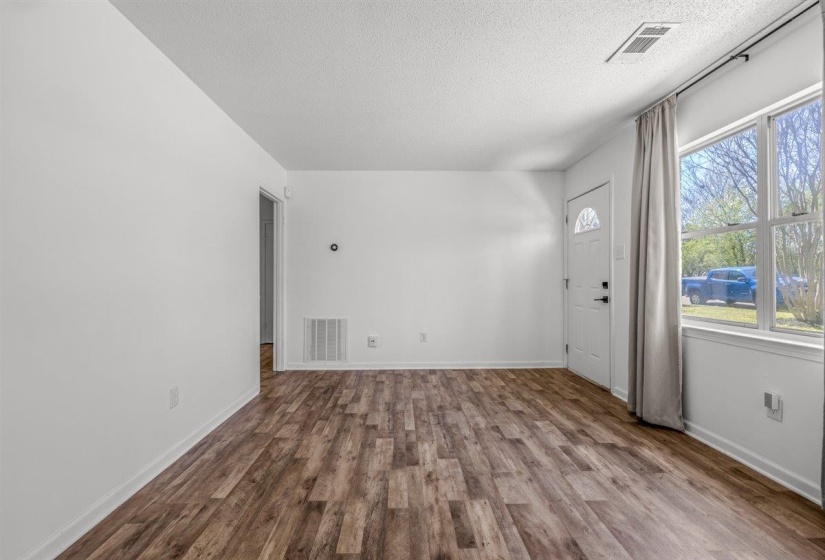 Foyer featuring dark wood finished floors and a textured ceiling