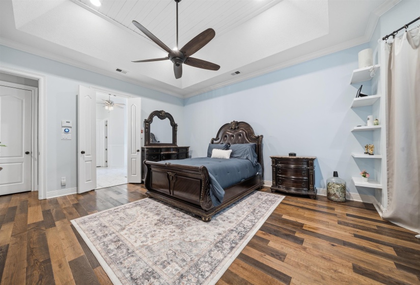 Spacious room featuring vaulted ceilings with beadboard paneling, a ceiling fan, and wood-finish flooring