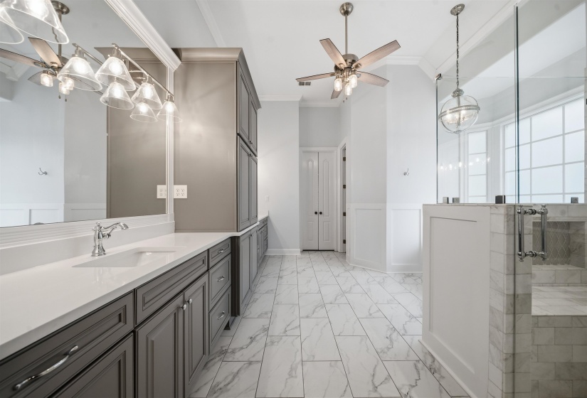 Spacious bathroom featuring an extended vanity with dual sinks, quartz countertops, and Beautiful cabinetry