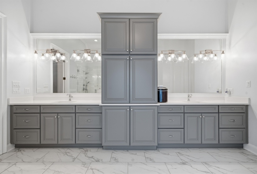 Dual vanity with gray shaker cabinetry, white countertops, undermount sinks, and polished chrome fixtures