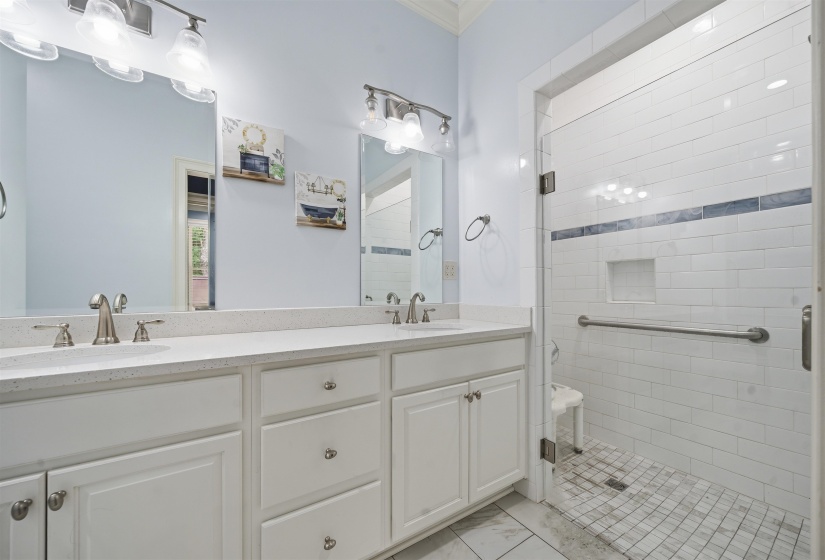 Dual vanity with white cabinetry, light-colored countertops, and brushed nickel fixtures