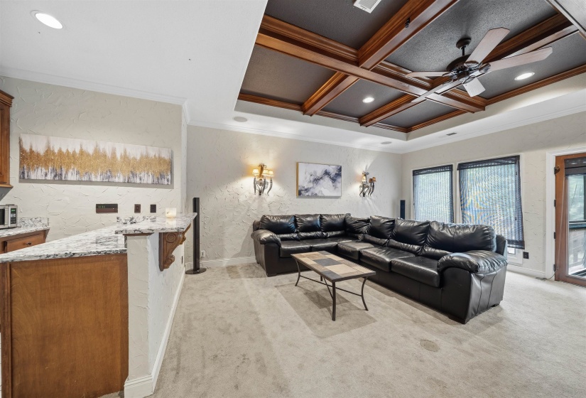 Featuring: Wet bar, Coffered ceiling with wood beams and ceiling fan