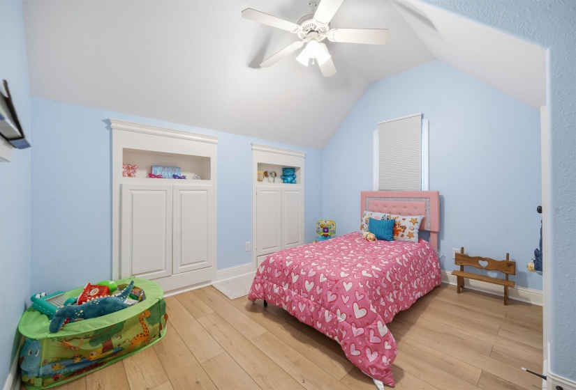 Bedroom featuring vaulted ceilings and light wood-finish flooring