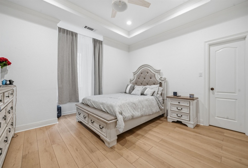 Room with tray ceiling, recessed lighting, and a ceiling fan