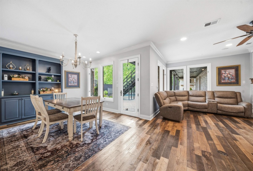 Spacious room featuring wood-finish flooring and light gray walls