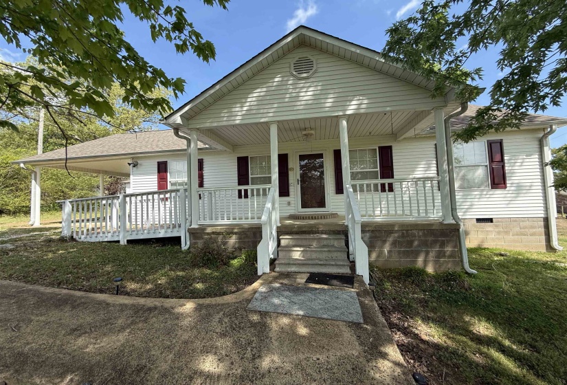 Single-story home featuring a covered porch and roof with shingles