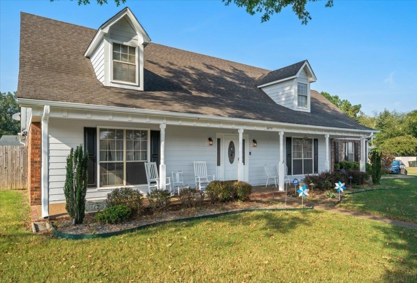 Cape cod-style house featuring covered porch and roof with shingles