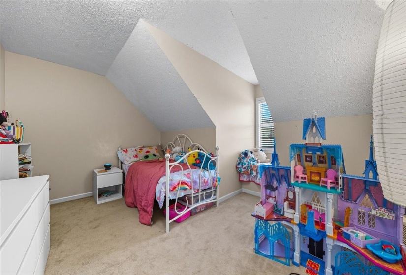Bedroom with light colored carpet and baseboards