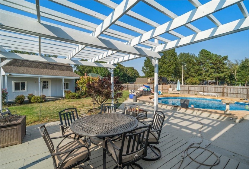 Wooden deck with outdoor dining area, a patio area, and a fenced backyard