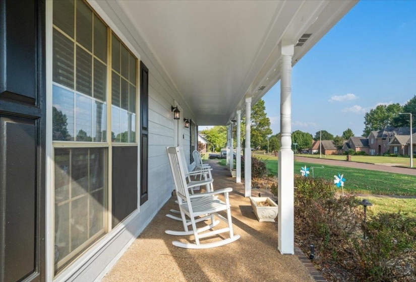 Covered porch featuring a residential view