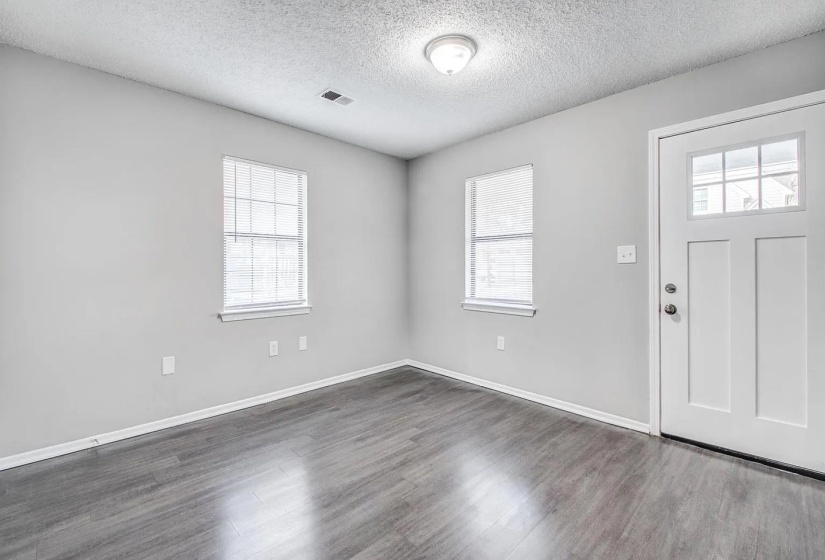 Entryway featuring a textured ceiling and dark wood-style flooring