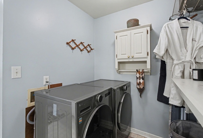 Laundry room featuring cabinet space and washer and clothes dryer