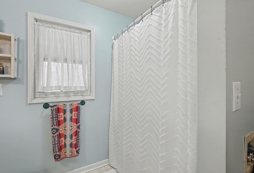Bathroom with curtained shower