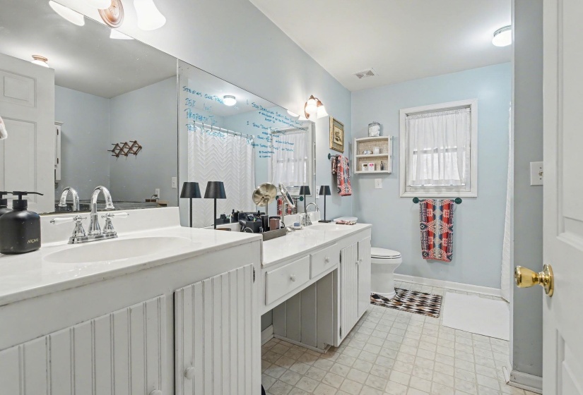 Full bath with vanity and a shower with shower curtain