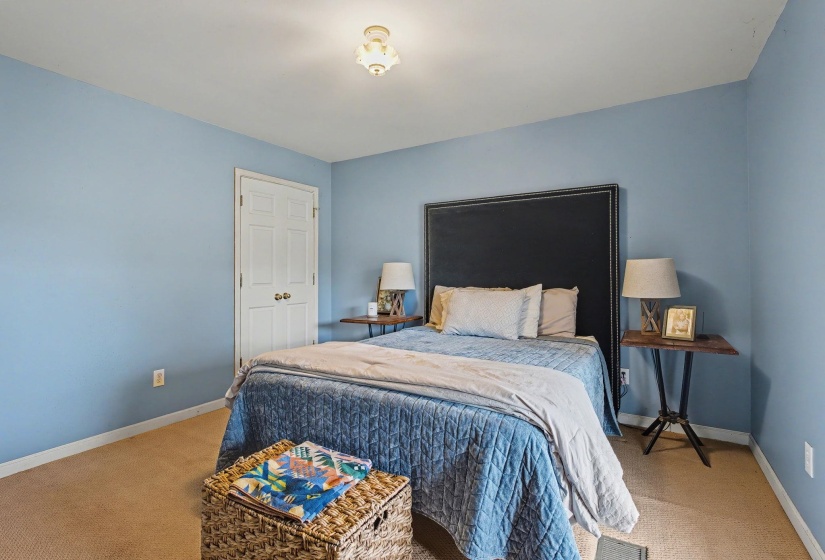 Bedroom with baseboards and light carpet