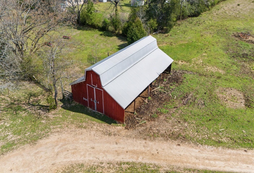 View of barn featuring a yard