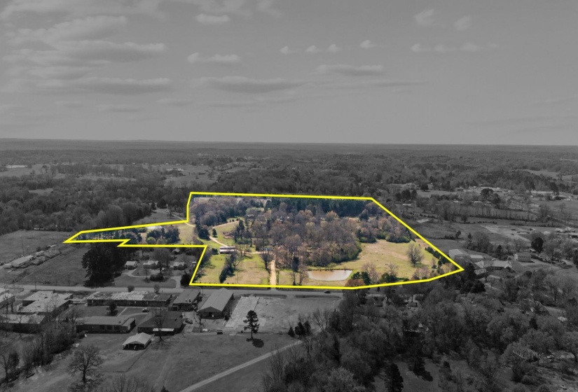 View of property location with a heavily wooded area and property boundaries highlighted