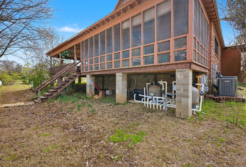 Back of house featuring stairs and a sunroom