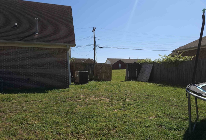 Fenced backyard with a trampoline