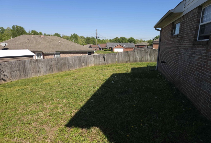 Fenced backyard with a residential view