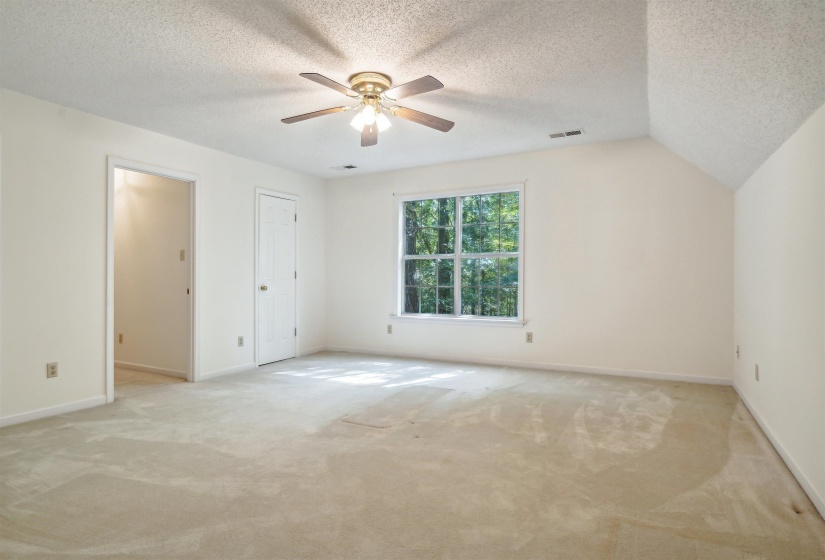 Unfurnished bedroom featuring light carpet and a ceiling fan