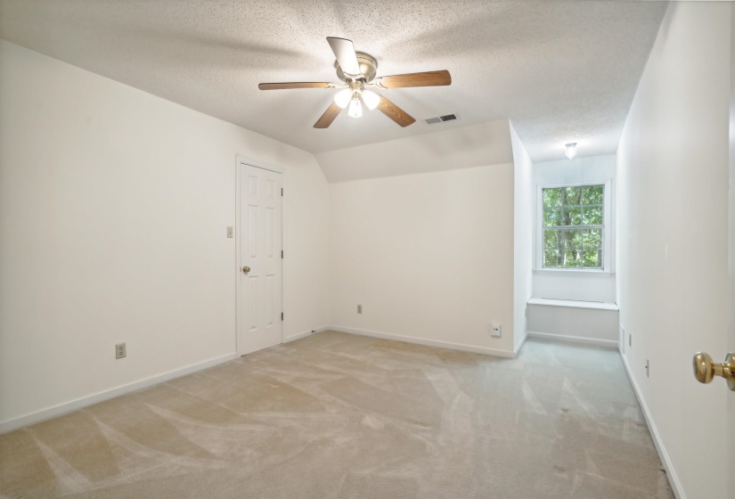Unfurnished room with light colored carpet and ceiling fan
