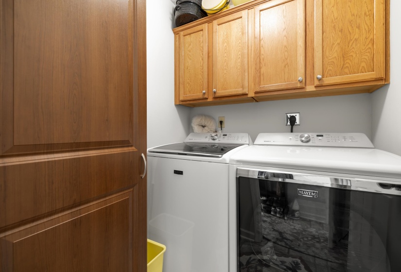 Laundry room featuring washing machine and clothes dryer and cabinet space