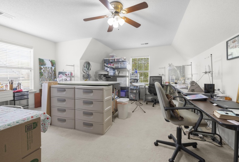 Office space featuring light carpet and a ceiling fan