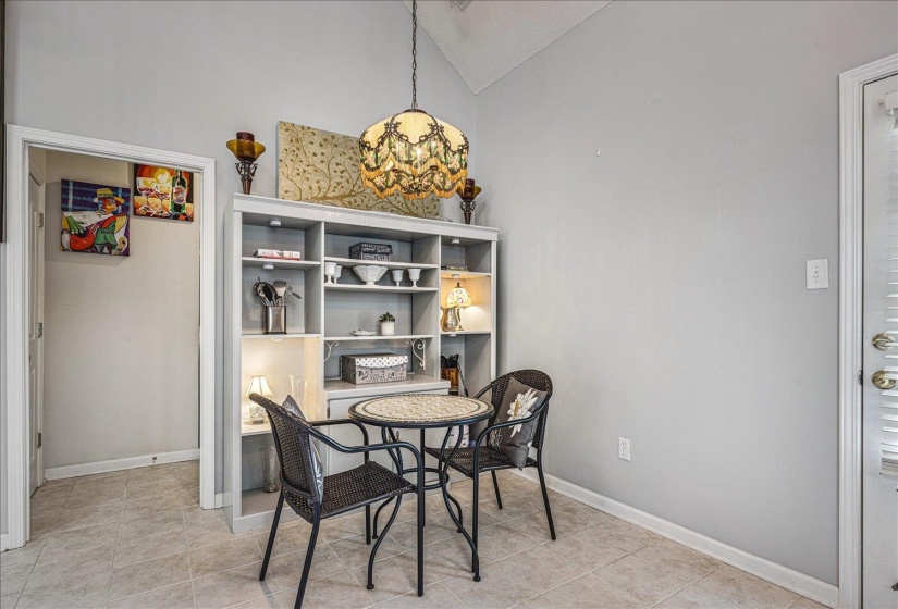 Dining room featuring vaulted ceiling and light tile patterned flooring