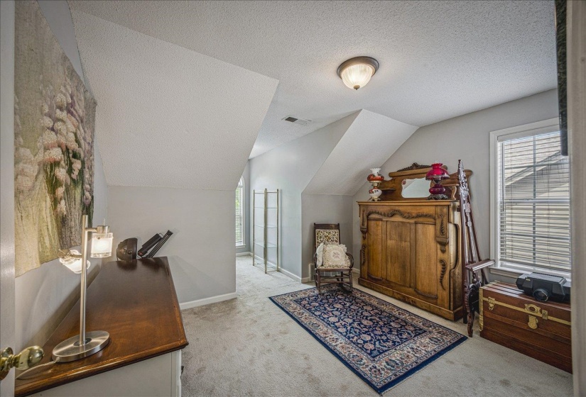 Office featuring light colored carpet and plenty of natural light