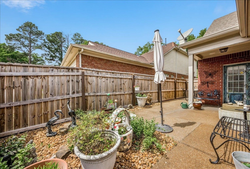 Fenced backyard with a patio