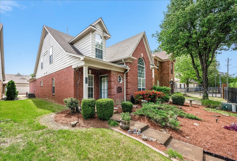 View of front of property featuring brick siding and roof with shingles