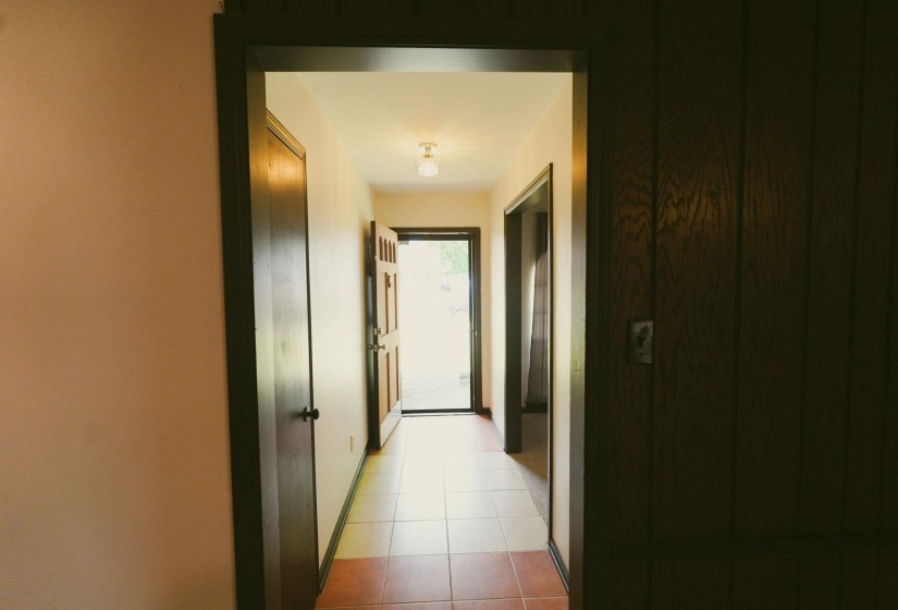Corridor featuring baseboards and light tile patterned floors