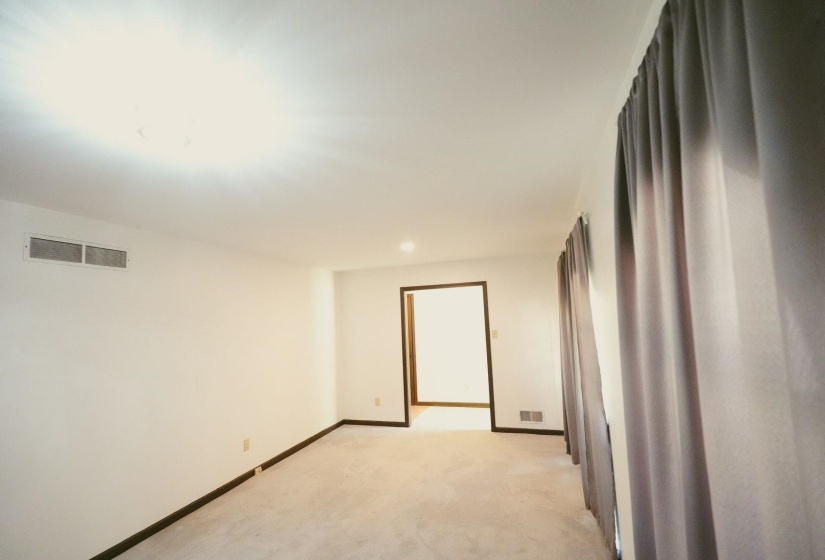 Spare room featuring light carpet and recessed lighting