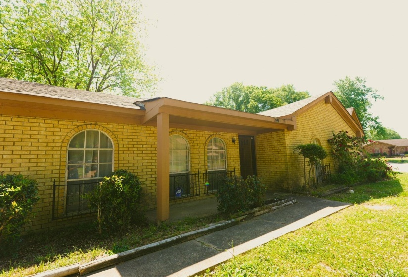 View of property exterior with brick siding