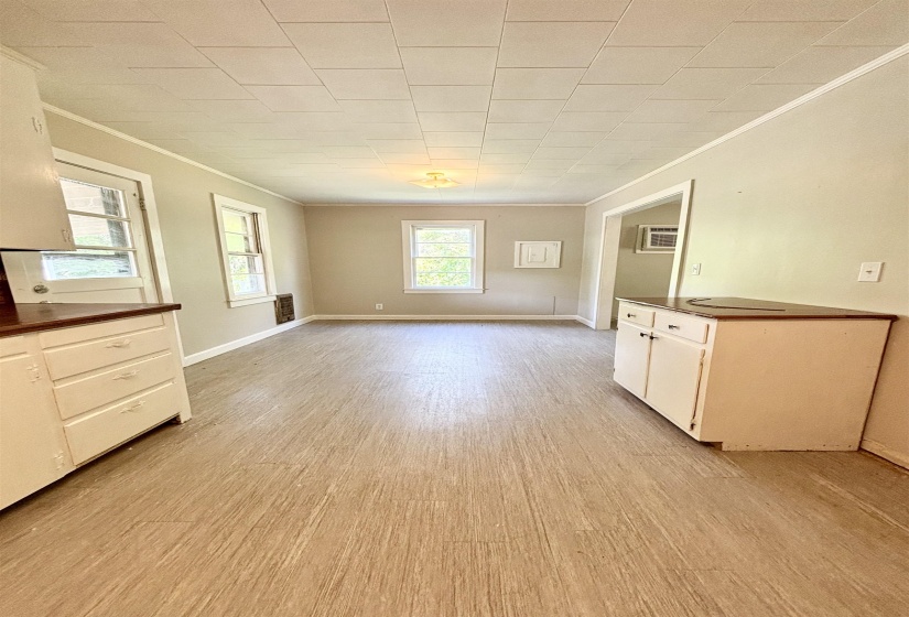 Unfurnished dining area featuring crown molding and light wood-style flooring