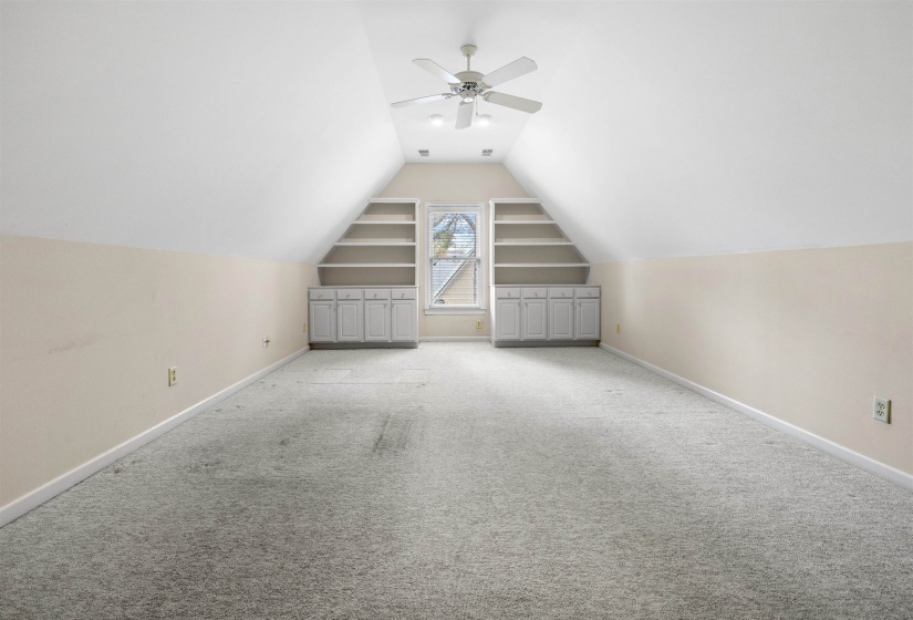 Bonus room featuring a ceiling fan and carpet floors