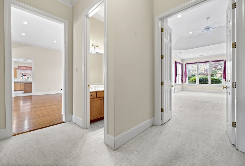 Corridor with light colored carpet, recessed lighting, and ornamental molding