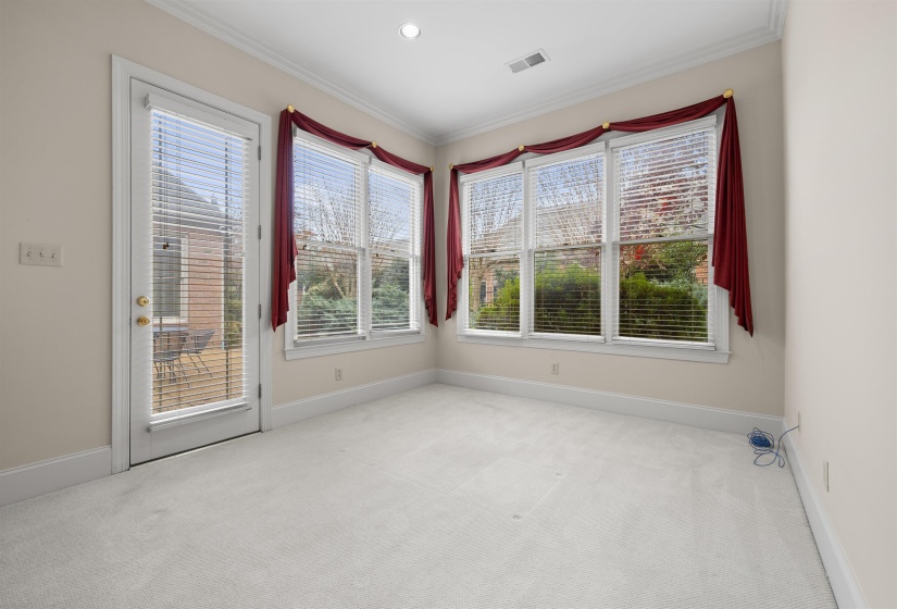 Carpeted empty room featuring ornamental molding and recessed lighting