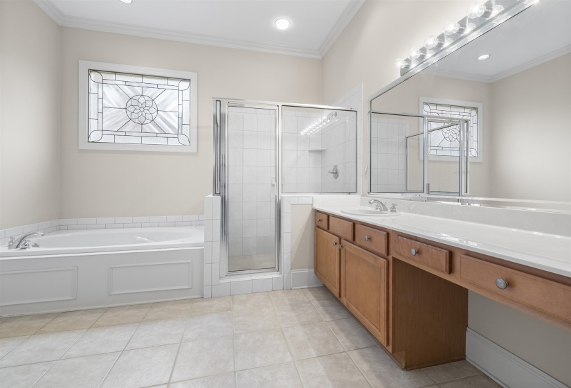 Full bathroom with vanity, a bath, a stall shower, ornamental molding, and light tile patterned flooring