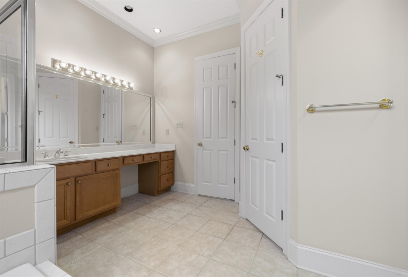 Bathroom with vanity, ornamental molding, light tile patterned floors, and recessed lighting