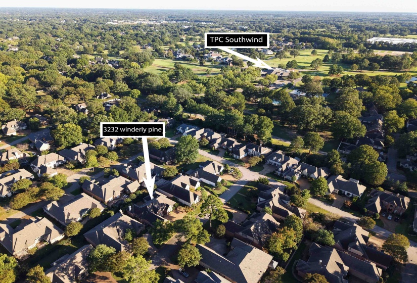 Aerial view of property and surrounding area featuring nearby suburban area