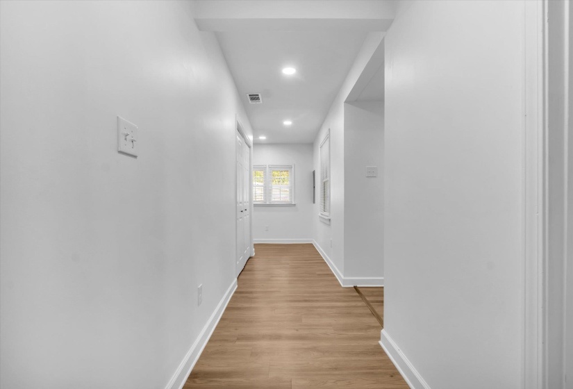 Corridor featuring light wood-type flooring and recessed lighting