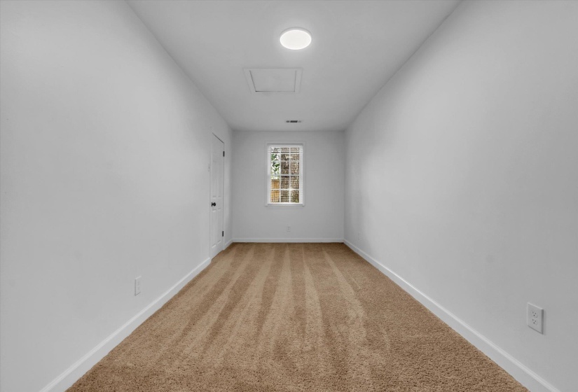 Empty room featuring baseboards and light colored carpet