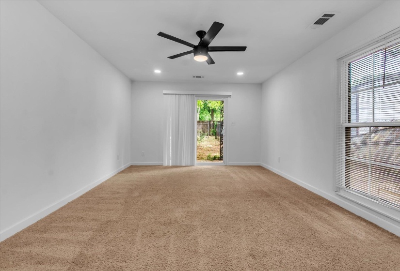Unfurnished room featuring light carpet, a ceiling fan, and recessed lighting