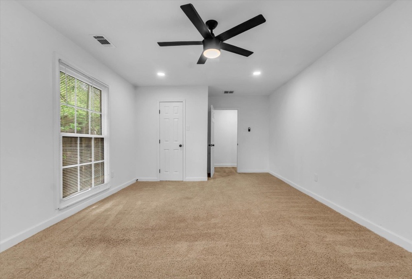 Empty room with a ceiling fan, light colored carpet, and recessed lighting
