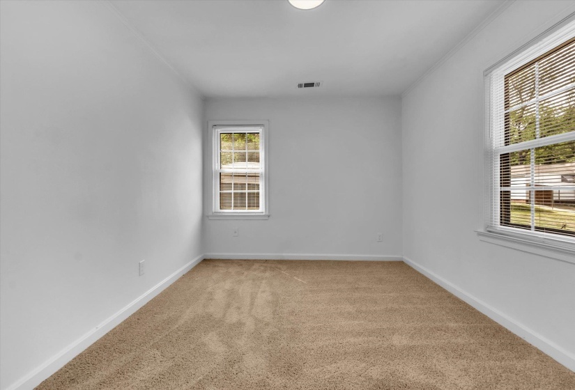 Empty room with light carpet and crown molding
