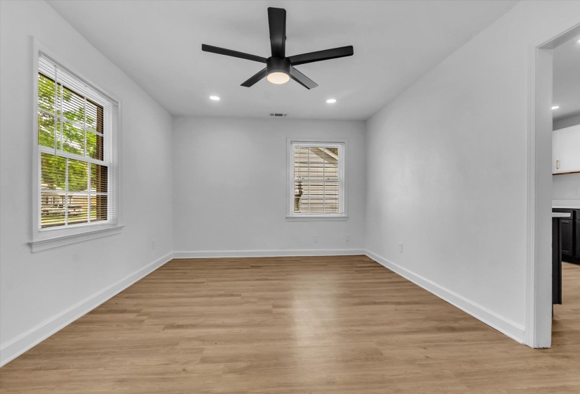 Spare room with light wood-style flooring, a ceiling fan, and recessed lighting
