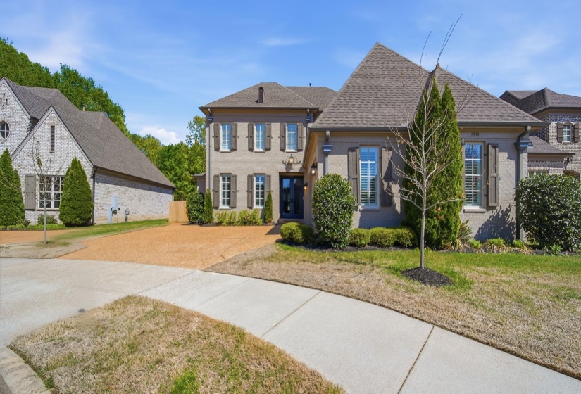 View of front of house featuring a front yard, brick siding, driveway, and a shingled roof