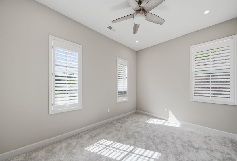 Unfurnished room with carpet flooring, healthy amount of natural light, ceiling fan, and recessed lighting